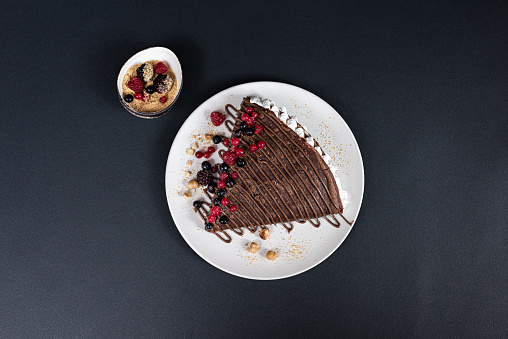 Sweet and tasty crepe with chocolate, fresh berries, hazelnuts and more.