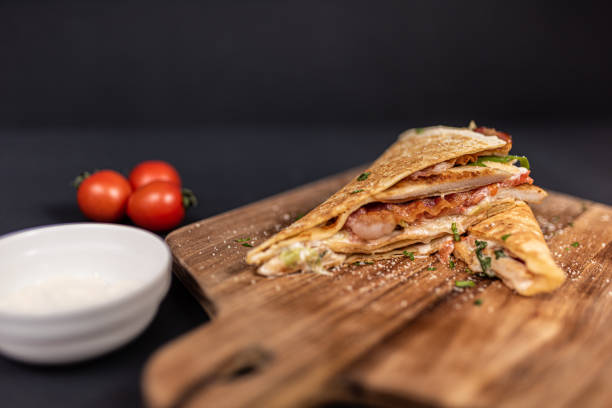 istock Crepes, thin pancakes with chicken meat, bacon, tomato and iceberg lettuce. 1297860621
