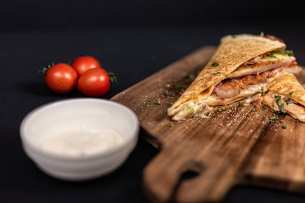 istock Crepes, thin pancakes with chicken meat, bacon, tomato and iceberg lettuce. 1297860692