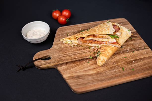 istock Crepes, thin pancakes with chicken meat, bacon, tomato and iceberg lettuce. 1297860700