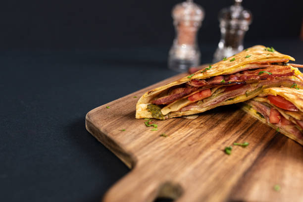 istock Crepes, thin pancakes with bacon, cheese,iceberg lettuce and tomato. 1297861397