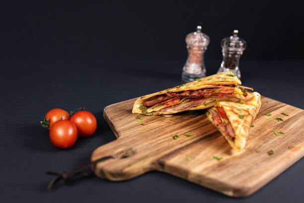 istock Crepes, thin pancakes with bacon, cheese,iceberg lettuce and tomato. 1297861454