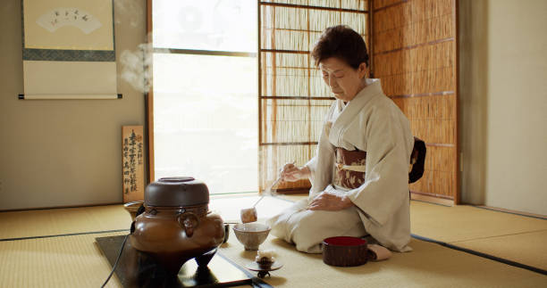 istock Tea Ceremony Hostess Ladling Water Into Small Bowls 1297863299
