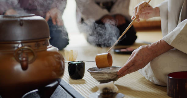 istock Hostess Ladling Water Into Bowl at Tea Ceremony 1297863305