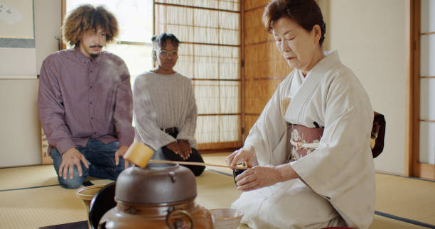 istock Guests Watching Hostess at Japanese Tea Ceremony 1297863306