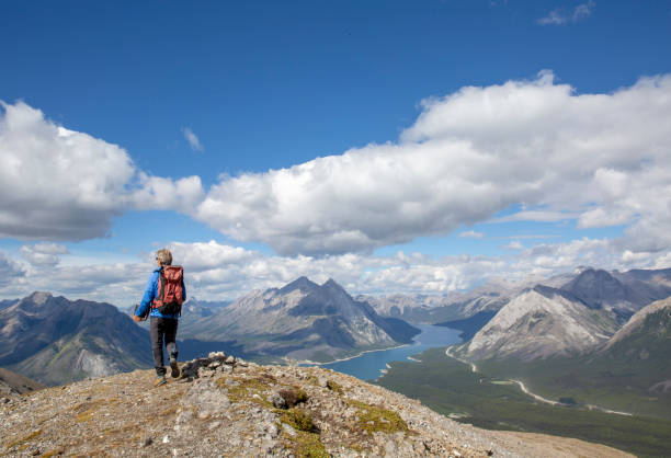 istock Male mountaineer reaches mountain summit 1297864014