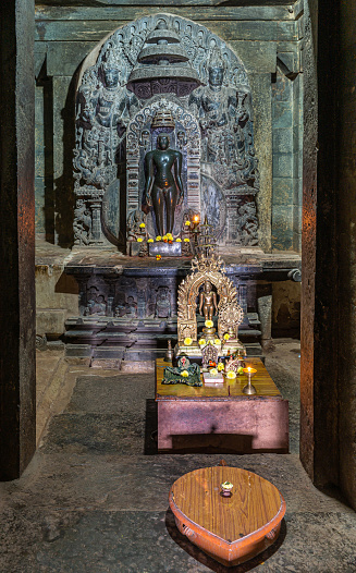Lakkundi, Karnataka, India - November 6, 2013: Brahma Jinalaya temple. Closeup of inner Sanctum with idol statue and small gift altar in front.