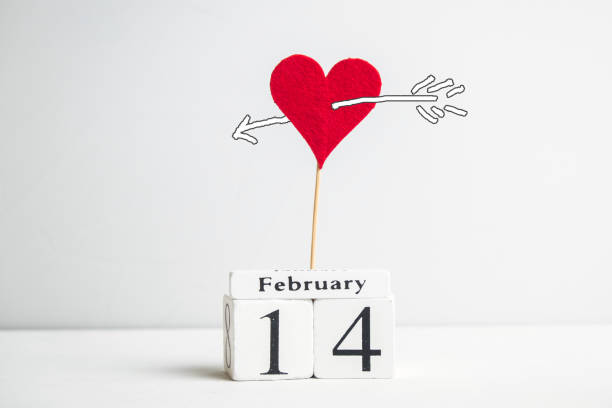 istock February 14 concept with heart on stick and arrow 1297866103