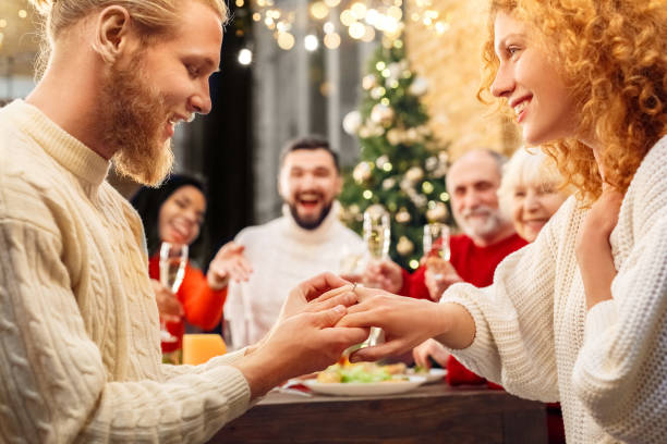 istock Man making propose and puts wedding ring on woman finger 1297866770
