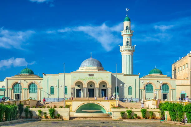 People sit in front of the Great Mosque of Asmara in downtown Asmara, Eritrea, East Africa on a sunny day.