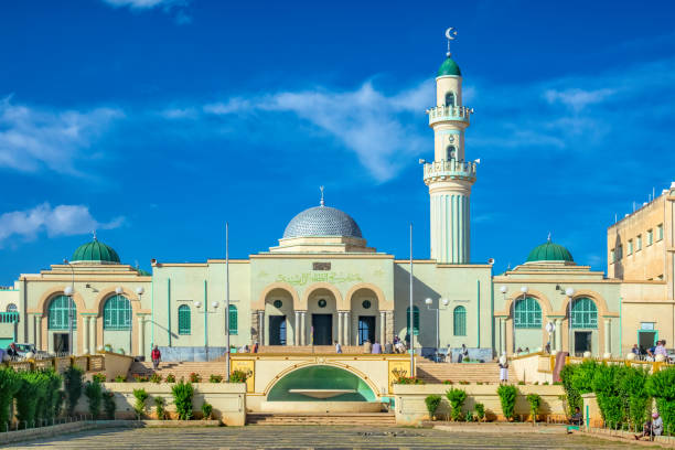 Great Mosque of Asmara Eritrea People sit in front of the Great Mosque of Asmara in downtown Asmara, Eritrea, East Africa on a sunny day. eritrea stock pictures, royalty-free photos & images