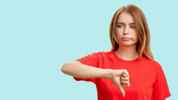 istock dislike gesture disappointed woman thumb down 1297866799