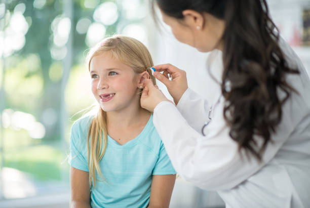 istock Girl gets a hearing aid 1297866879
