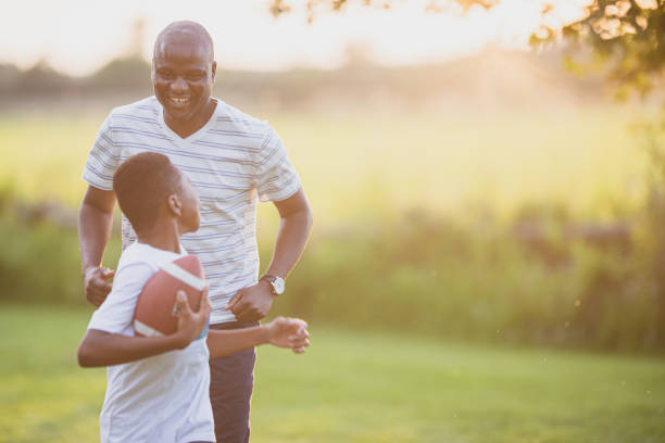istock Father and son playing backyard football 1297866896