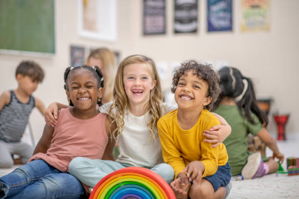 Preschool best friends A multi ethnic group of preschool children smiles for the camera. community center stock pictures, royalty-free photos & images
