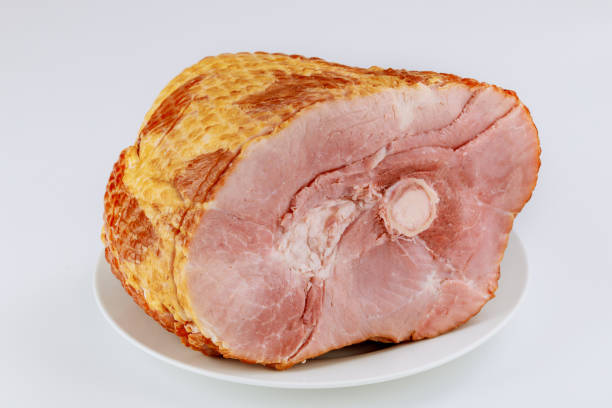 istock Spiral sliced whole ham isolated on white background. 1297867050