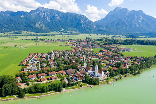 Village by the lake and Alps, aerial view