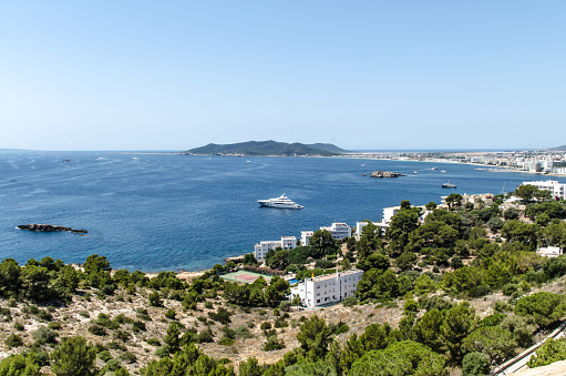 Ibiza, Spain; June 27th, 2018- Ibiza is one of the Balearic islands, an archipelago of Spain in the Mediterranean Sea. It's well known for the lively nightlife in Ibiza Town and Sant Antoni, where major European nightclubs have summer outposts. It’s also home to quiet villages, yoga retreats and beaches, from Platja d'en Bossa, lined with hotels, bars and shops, to quieter sandy coves backed by pine-clad hills found all around the coast