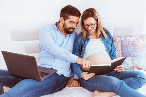 istock Pregnant woman and her husband work from home 1297870115