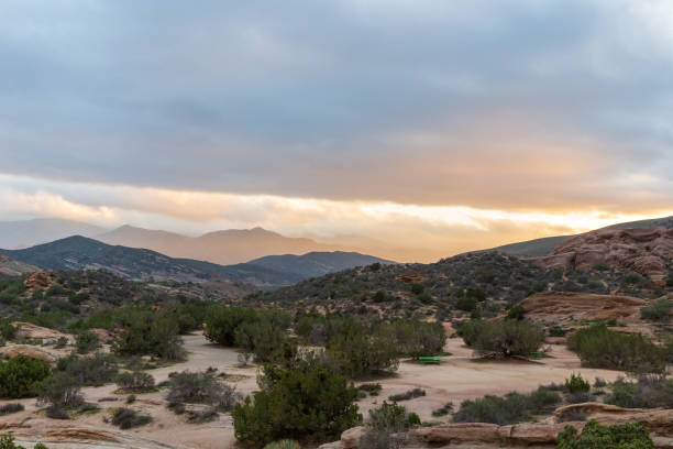 istock Desert sunset with mountains and clouds at Vasquez Rocks 1297871731