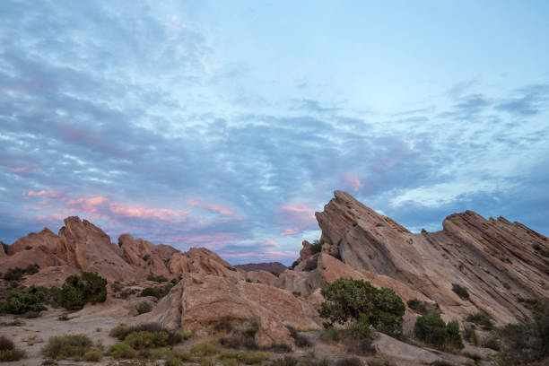istock red rocks and blue sky with pink clouds in Vasquez Rocks, California 1297871756