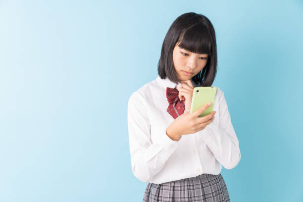 istock girl student,school uniform,smart phone,think, 1297871986