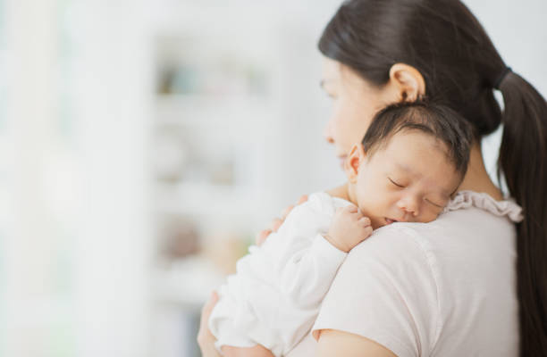 istock Mother holding sleepy newborn 1297877496