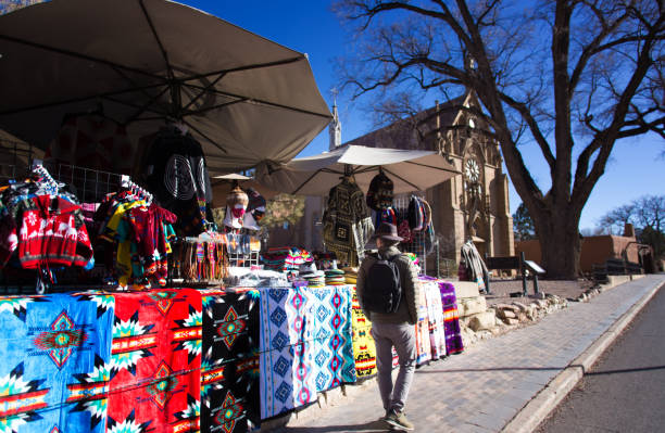 istock Santa Fe, NM: Tourist Walks Past Market Stall Downtown 1297878119