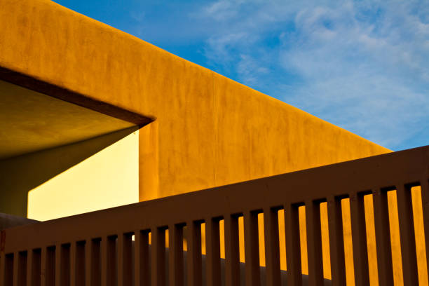 Santa Fe, NM: Sunlit Adobe Architecture at Dusk Close-Up. Copy space available in the sky.