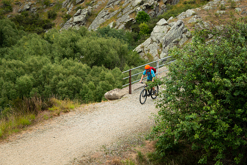 A young man cycling the Otago Central Rail Trail on the Poolburn Viaduct, South Island, New Zealand