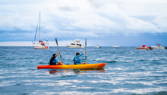 A father and son out at sea on a kayak in Costa Rica