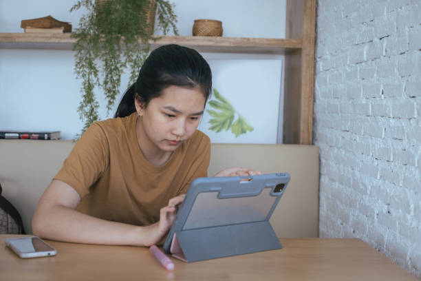 istock Asian girl Learn online at home school 1297894343