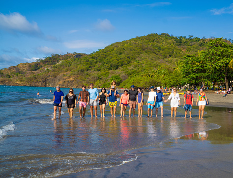 Family and friends walking on a beach in Costa Rica