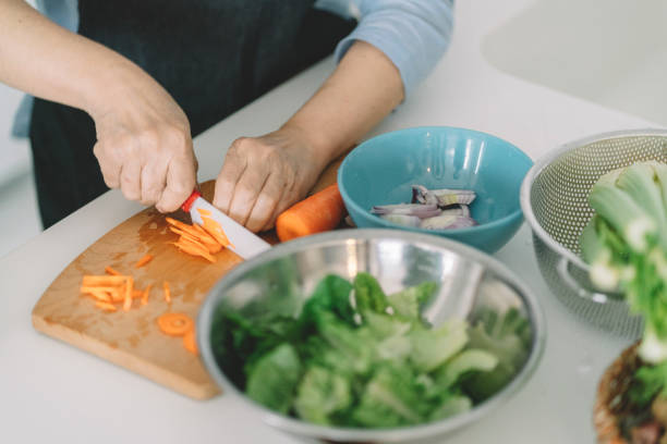 istock asian chinese grandma cutting carrot for breakfast at kitchen 1297896997