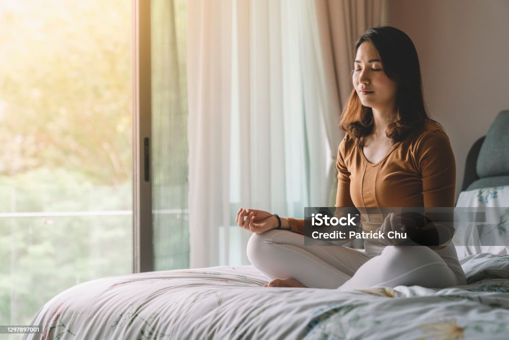 asian chinese woman meditating at bedroom home activity Meditating Stock Photo
