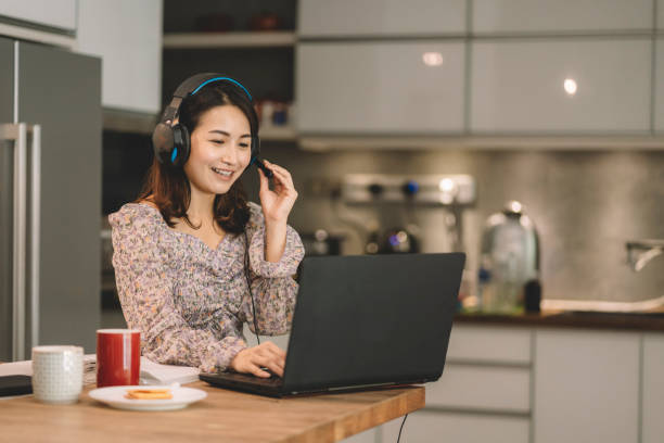 istock asian chinese woman working from home as customer support 1297897036