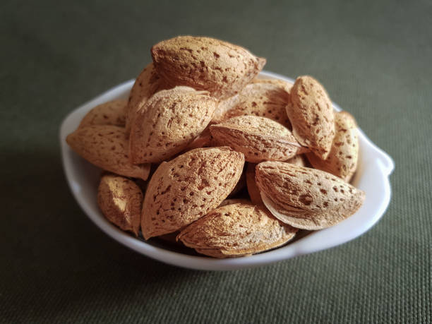 istock almonds on burlap, tasty snack 1297898623