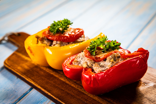 Roasted stuffed pepper with minced-meat and rice on wooden table