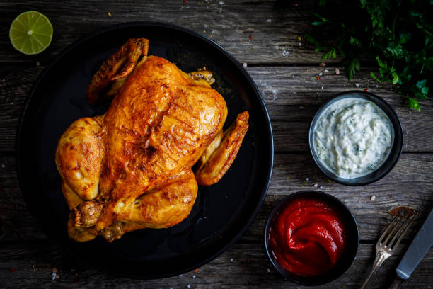 istock Roast chicken on wooden table 1297899440