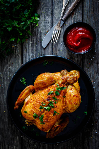 istock Roast chicken on wooden table 1297899459
