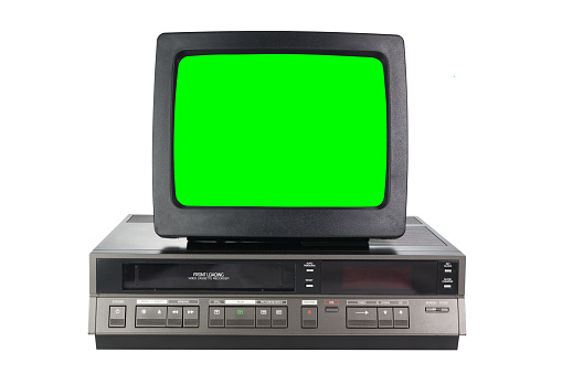 Old black vintage green screen TV and VCR from 1980s, 1990s, 2000s isolated on white background.