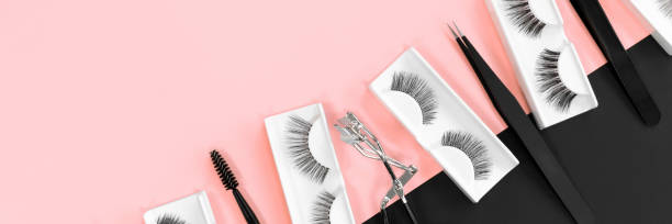 istock Various tools for eye lash extensions on a trendy pastel pink and black background. Banner. Concept. Eyelash curler, tweezers. Makeup accessories. Cosmetics. Fake eyelashes. Place for text. Top view. 1297902970