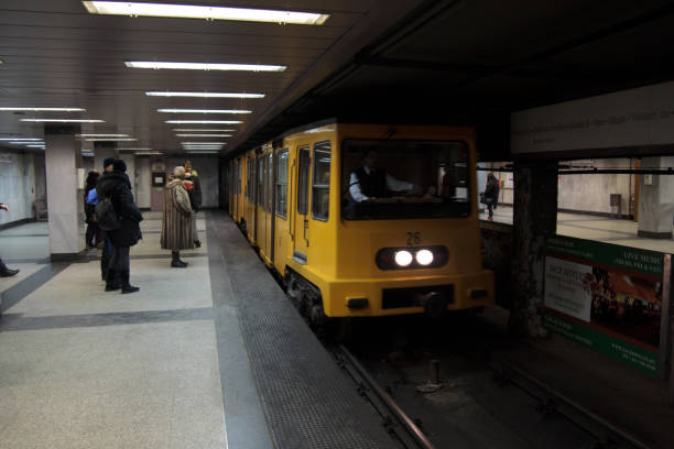 Train arrives to Deák Ferenc tér Budapest Metro station Budapest, Hungary - January 2015. Train arrives to Deák Ferenc tér (Budapest Metro) station gellert stock pictures, royalty-free photos & images