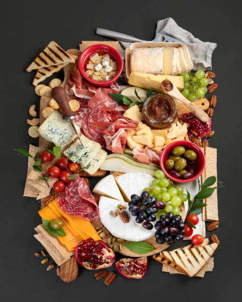 Appetizers table. Appetizers table. Cheese, fuits and meat board on dark  background. Top view"n pomegranate in spanish stock pictures, royalty-free photos & images