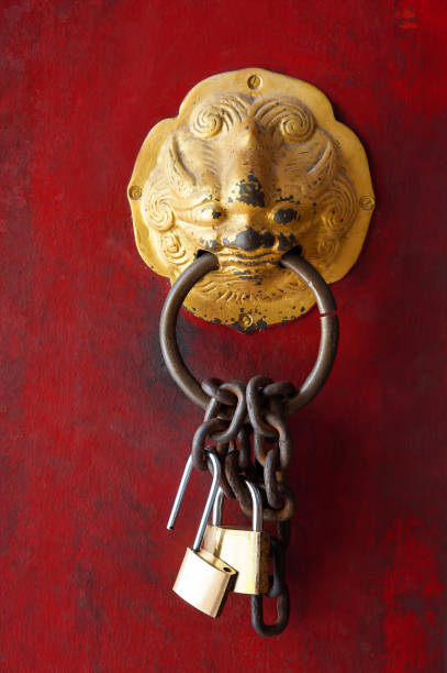istock Ancient red lion door knob and lock chain 1297906053