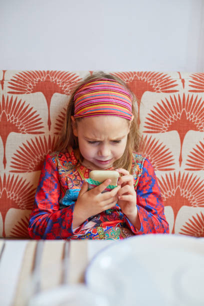 girl with angry face watching a smartphone