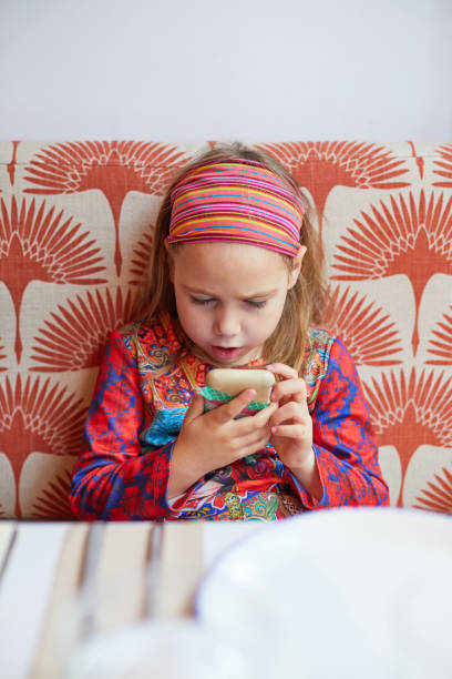 istock girl with a surprised face watching a mobile phone 1297906810
