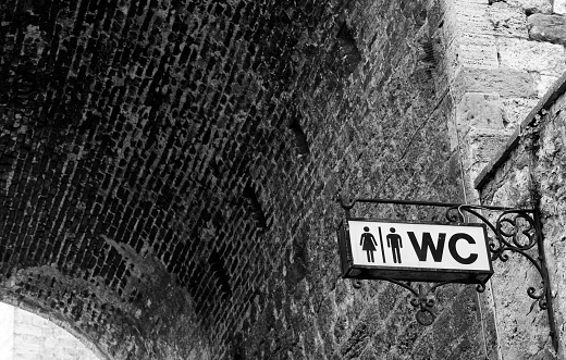 WC sign in medieval village, San Gimignano, Chianti region, Tuscany, Italy.