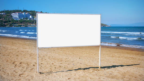 istock Big information advertising white banner with empty place for mockup on sandy beach 1297909738