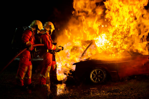 istock Firefighter training, fireman using water and extinguisher to fighting with fire flame in an emergency situation., under danger situation all firemen wearing fire fighter suit for safety. 1297915646